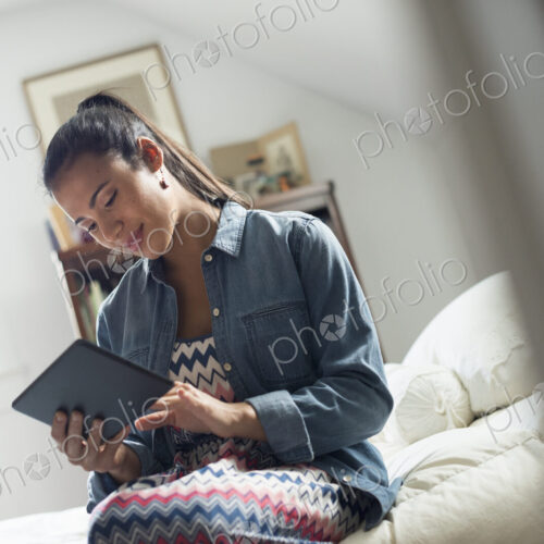 A young woman using a digital tablet.