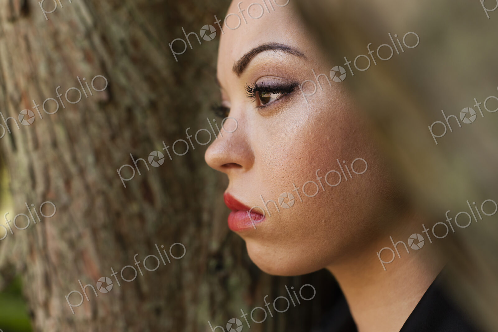 A young woman wearing makeup and a severe expression in a leather jacket.