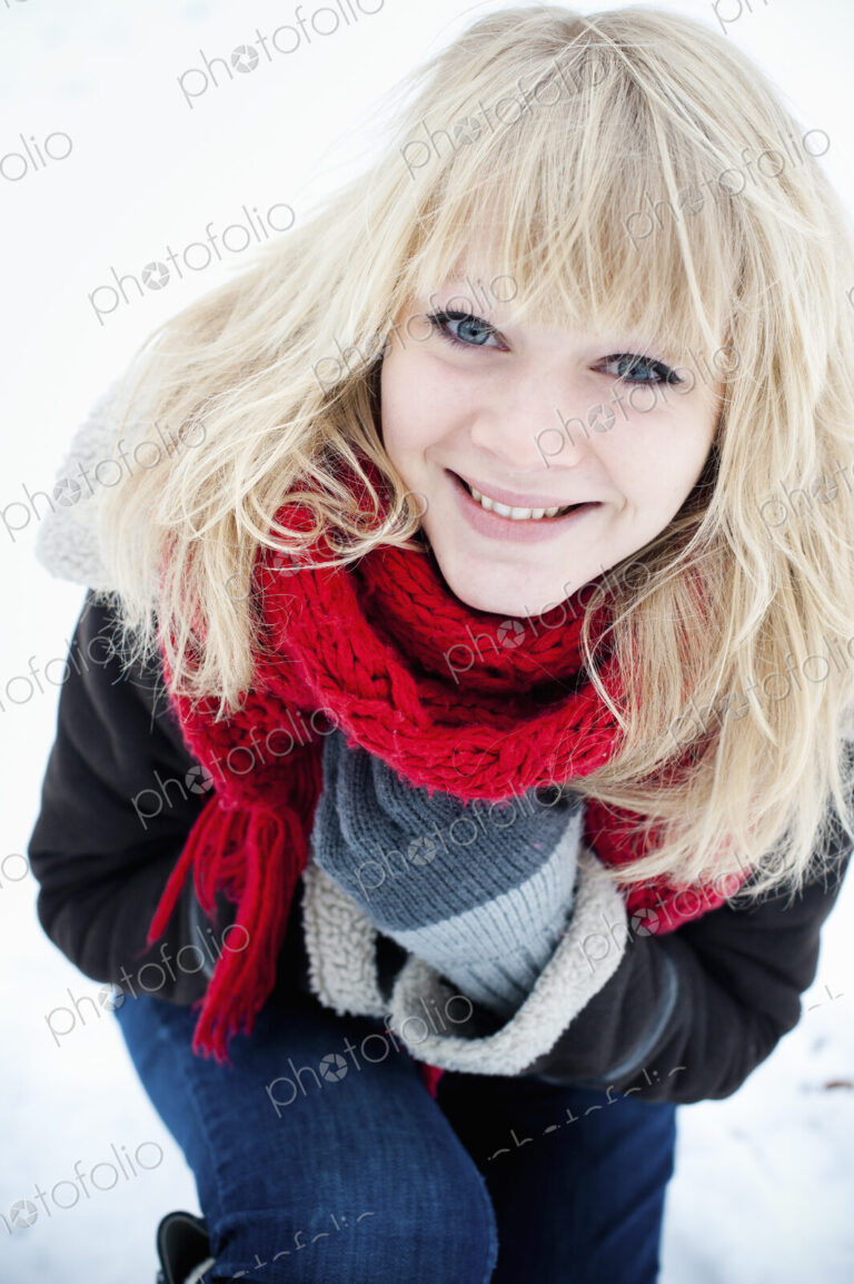 A young woman with blond hair in the snow.