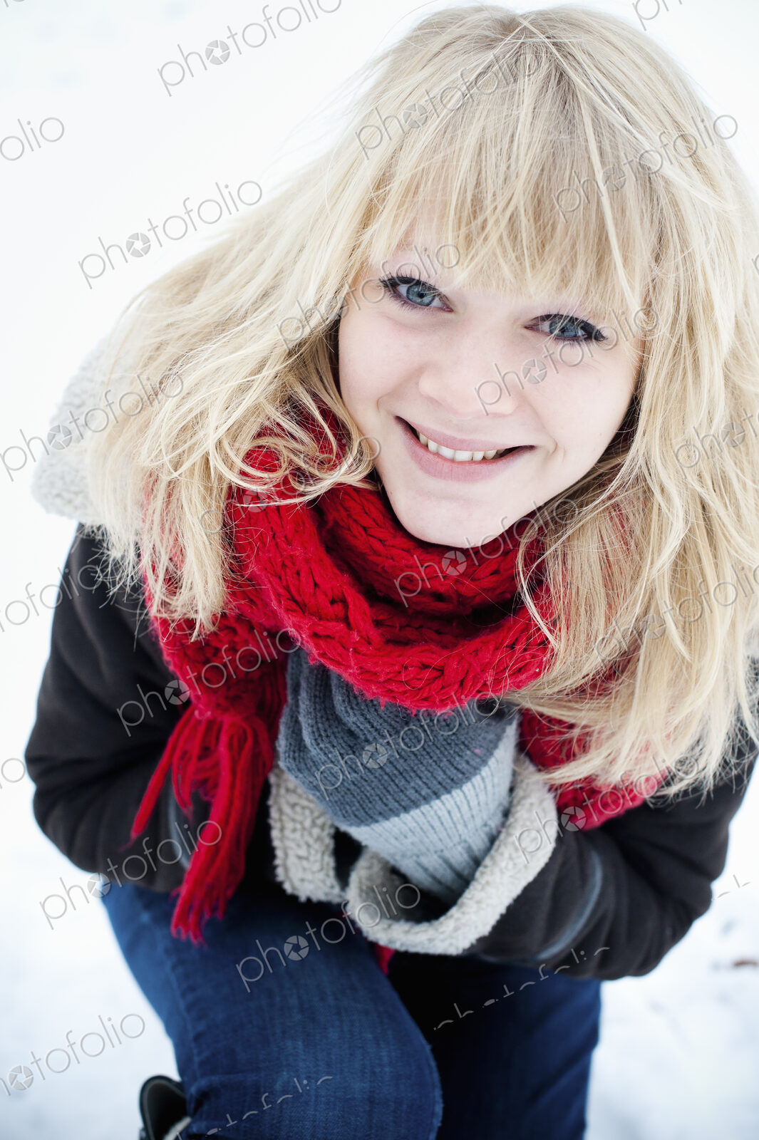 A young woman with blond hair in the snow.