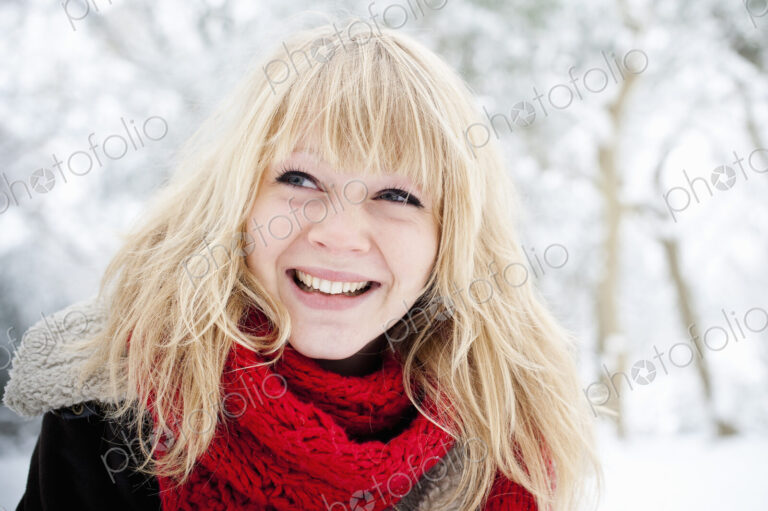 A young woman with blond hair in the snow.