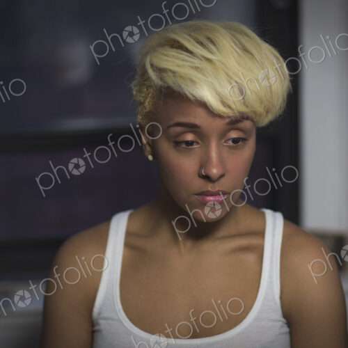 A young woman with blonde hair looking away from the camera. A young woman with blonde hair looking away from the camera.