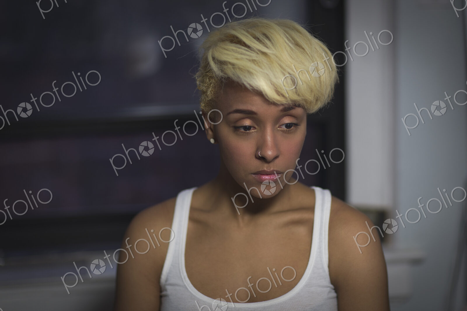 A young woman with blonde hair looking away from the camera.