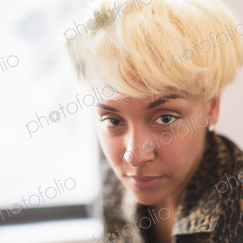 A young woman with blonde hair looking intently at the camera. A young woman with blonde hair looking intently at the camera.