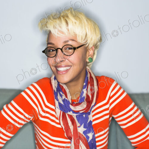 A young woman with blonde hair smiling broadly.