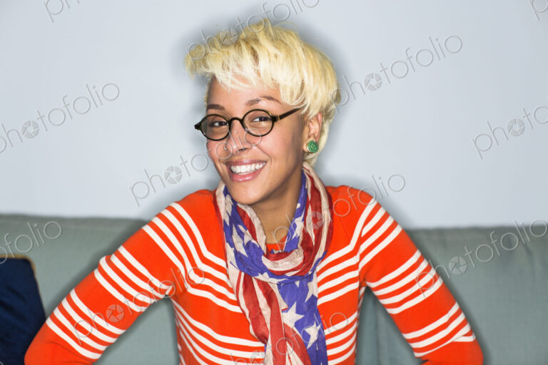 A young woman with blonde hair smiling broadly.