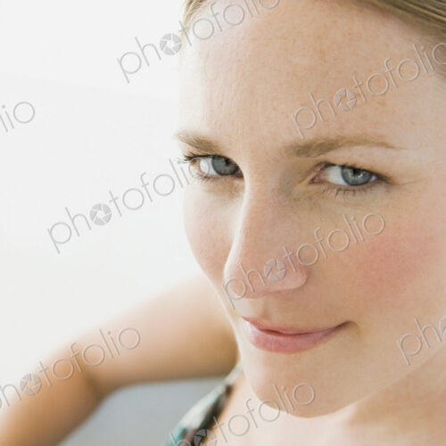 A young woman with blue eyes looking at the camera.