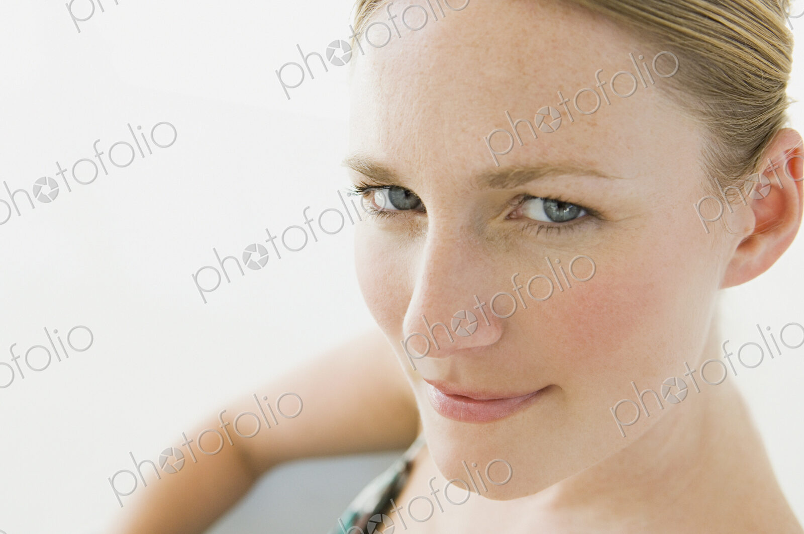 A young woman with blue eyes looking at the camera.