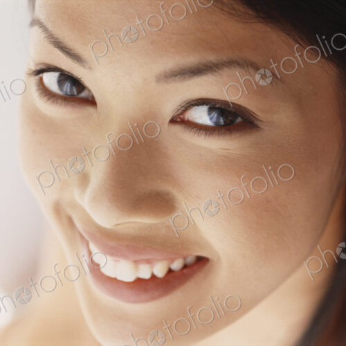 A young woman with brown eyes, smiling. Close up. A young woman with brown eyes, smiling. Close up.