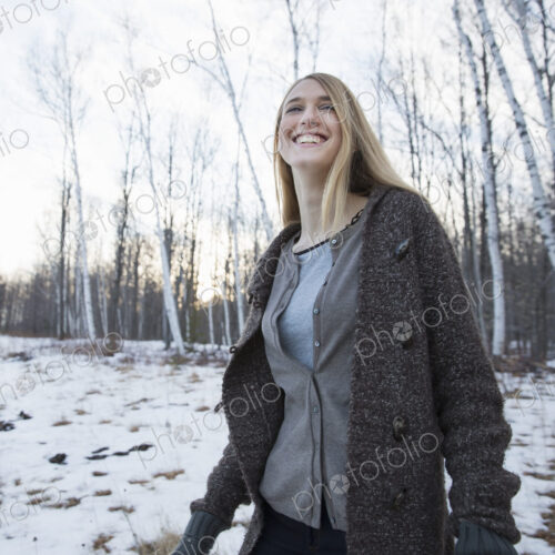A young woman with long blonde hair outdoors on a winter day. A young woman with long blonde hair outdoors on a winter day.