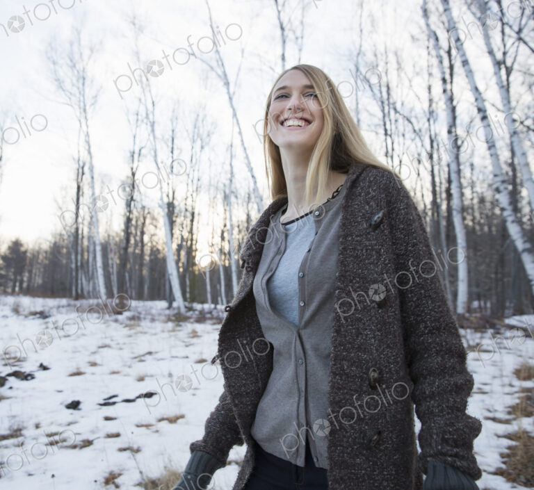 A young woman with long blonde hair outdoors on a winter day.