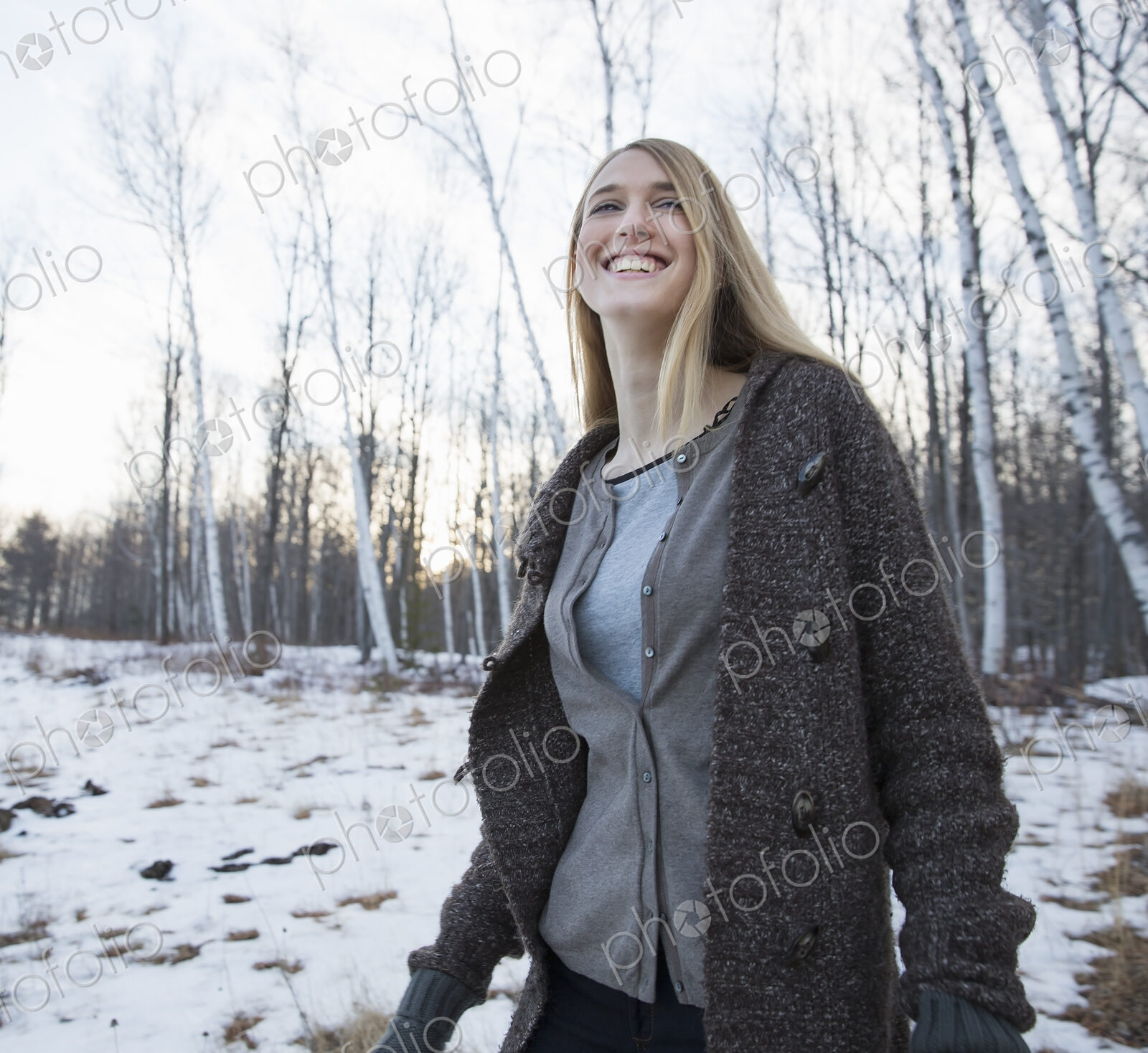 A young woman with long blonde hair outdoors on a winter day.