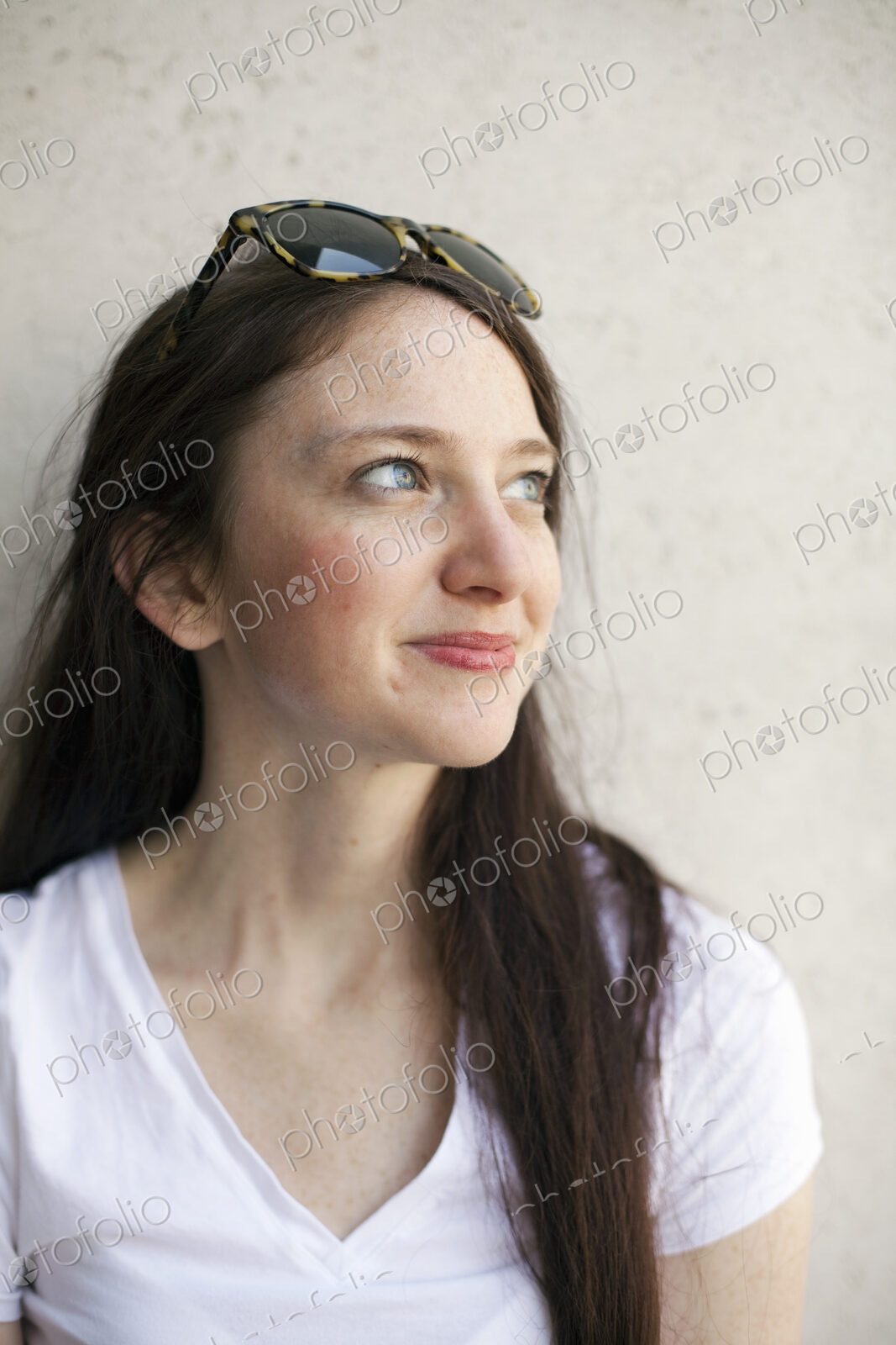 A young woman with long brown hair and sunglasses perched on her head. Wearing a white…
