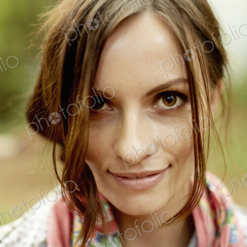 A young woman with long brown hair smiling at the camera.