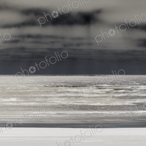 Abstract of breaking waves and moody sky at dusk Abstract of breaking waves and moody sky at dusk