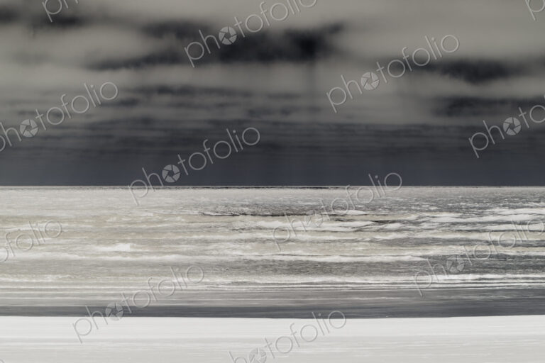 Abstract of breaking waves and moody sky at dusk