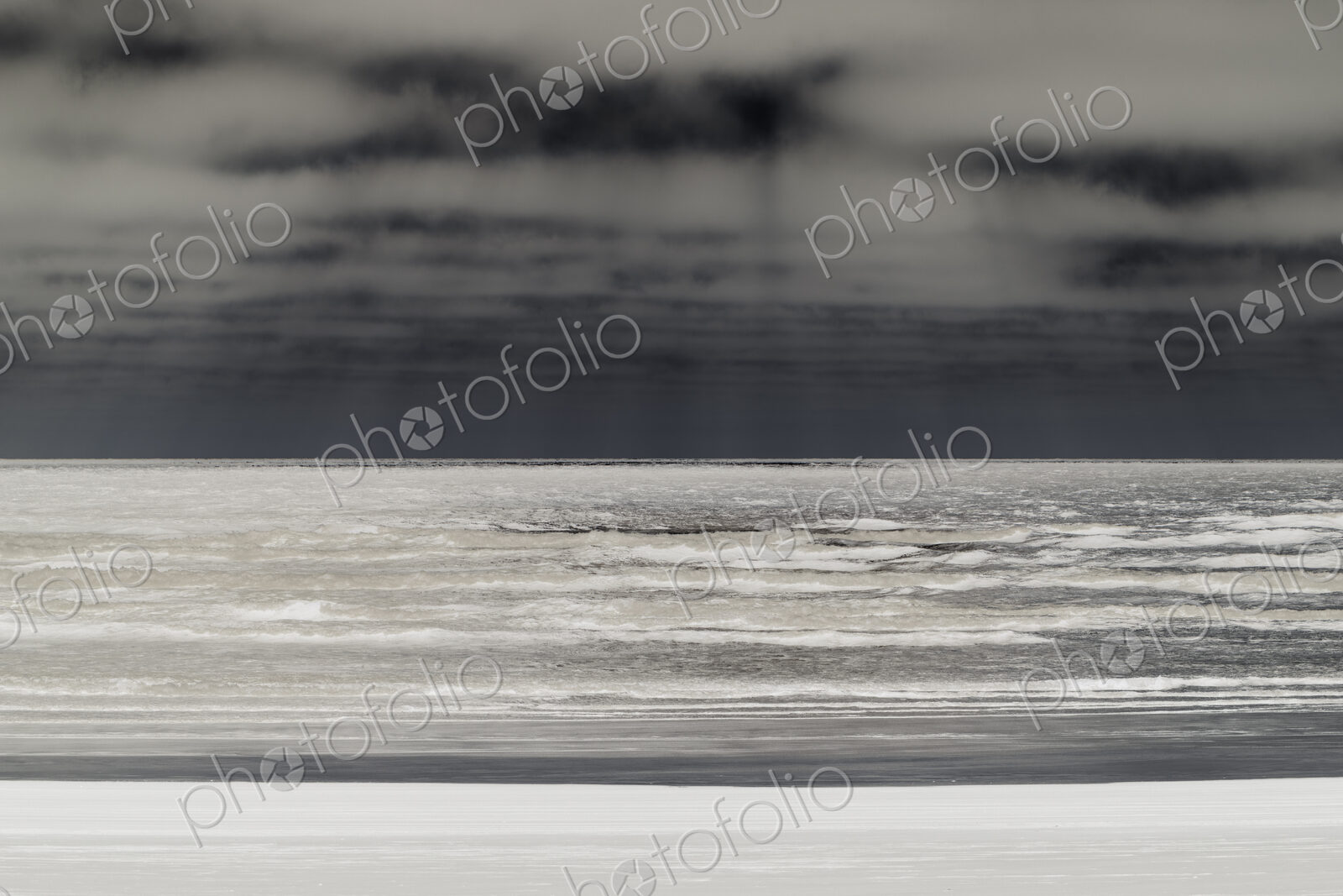 Abstract of breaking waves and moody sky at dusk