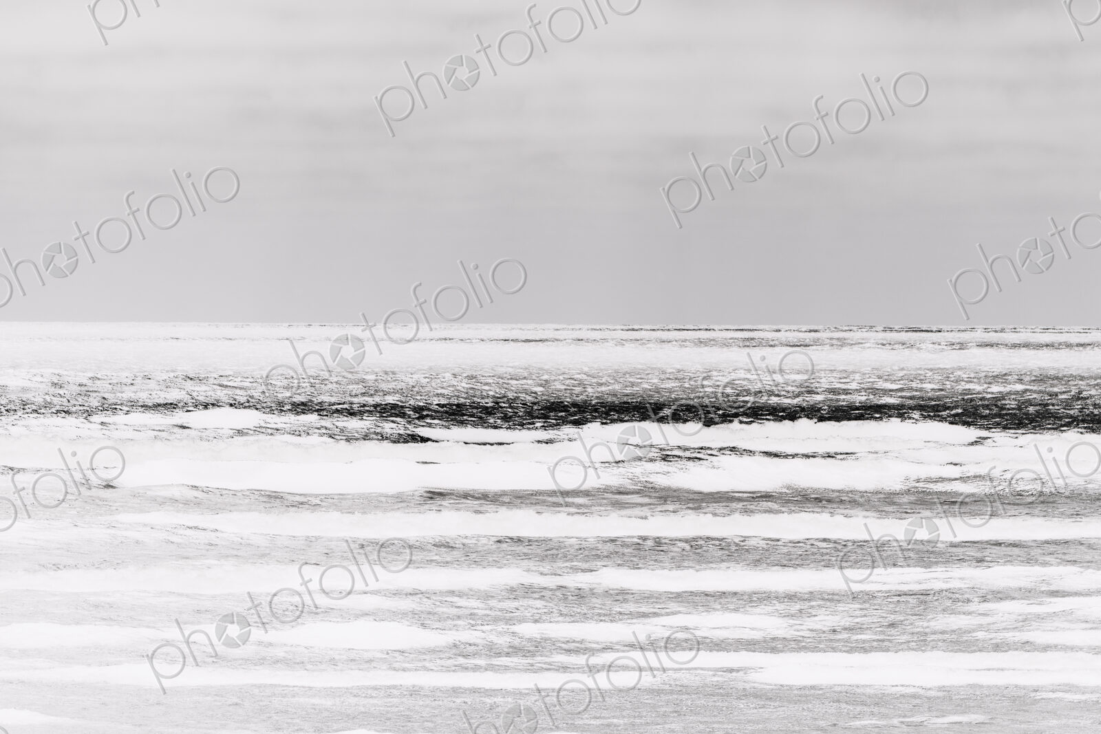 Abstract of breaking waves and moody sky at dusk