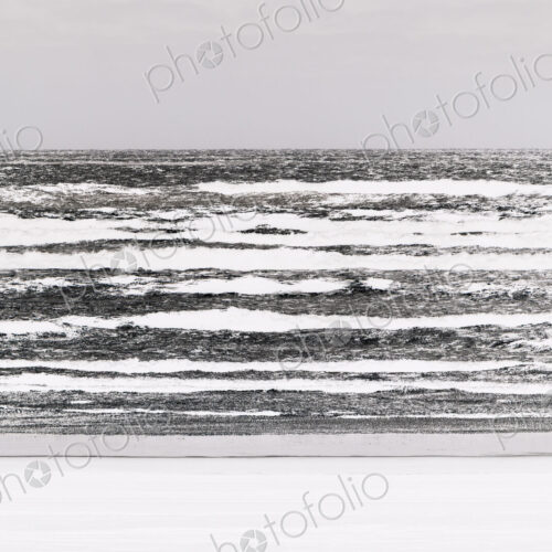 Abstract of breaking waves and moody sky at dusk Abstract of breaking waves and moody sky at dusk