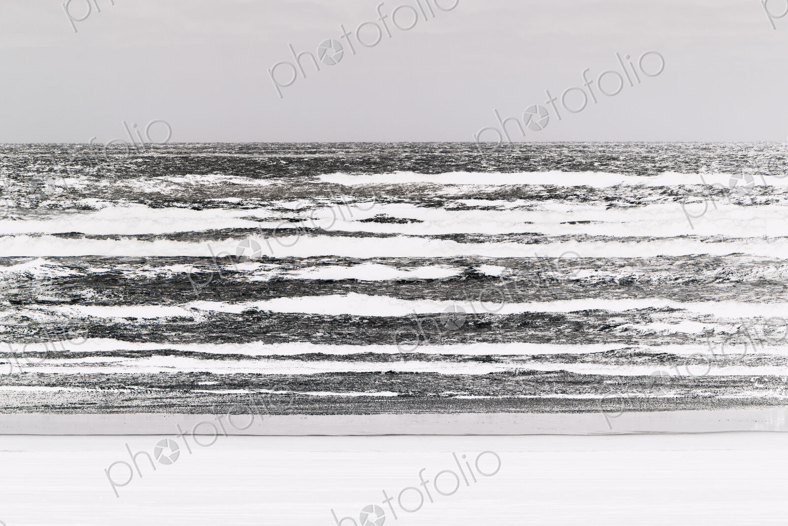 Abstract of breaking waves and moody sky at dusk