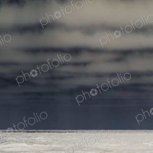 Abstract of breaking waves and moody sky at dusk Abstract of breaking waves and moody sky at dusk