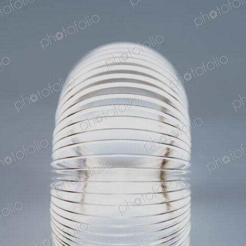 Abstract of metal coiled slinky, length of fine wire wound around and stretched, black… Abstract of metal coiled slinky, length of fine wire wound around and stretched, black…