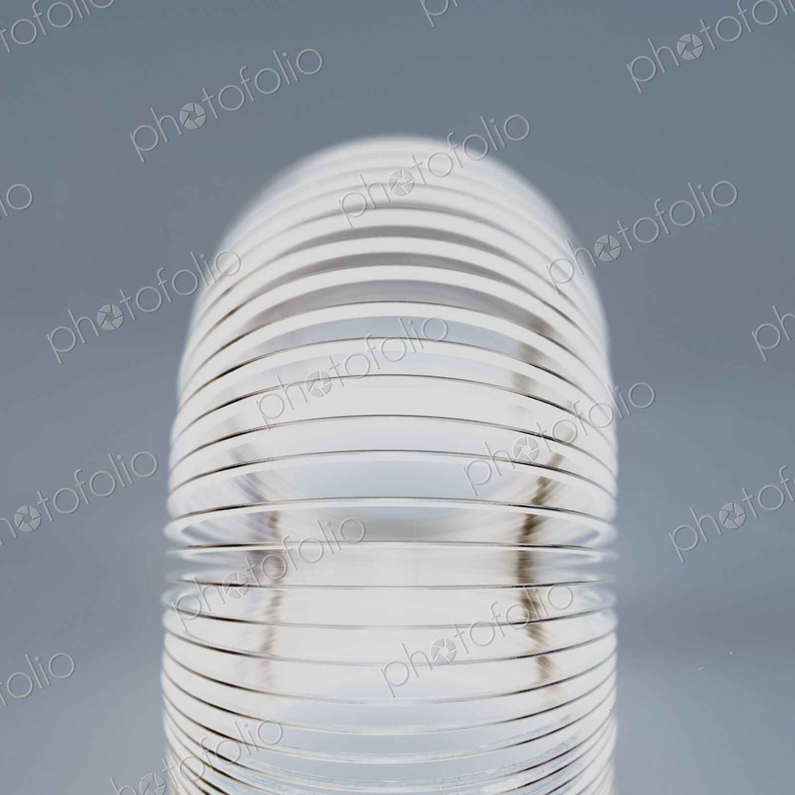 Abstract of metal coiled slinky, length of fine wire wound around and stretched, black…