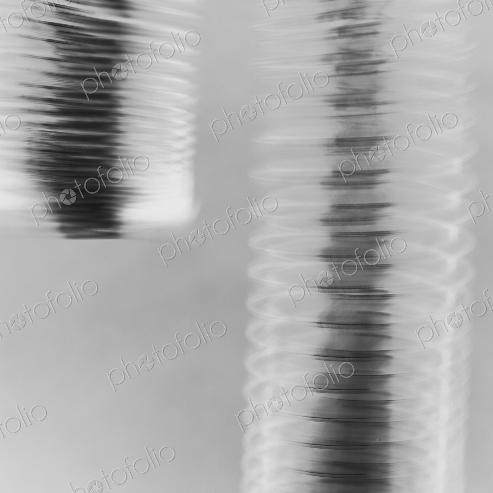 Abstract of metal coiled slinky, length of fine wire wound around and stretched, black…
