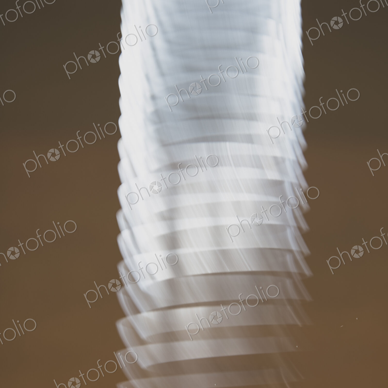 Abstract of metal coiled slinky, length of fine wire wound around and stretched, black…