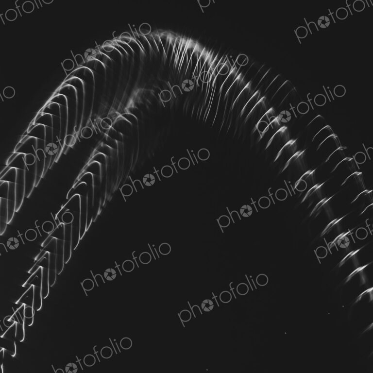 Abstract of metal coiled slinky, length of fine wire wound around and stretched,…