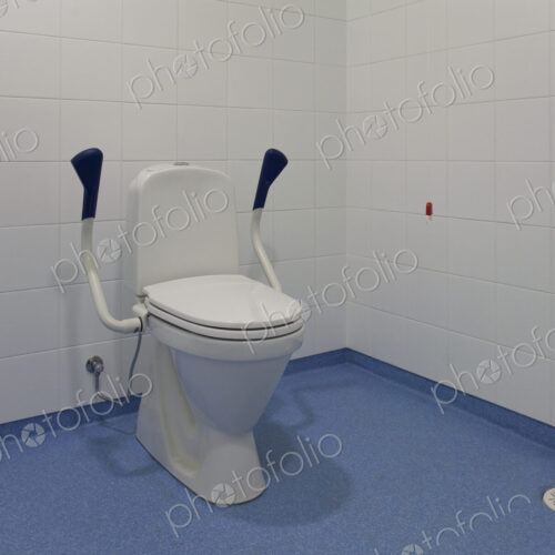 Accessible Toilet, a spacious cubicle with toilet bowl and adjustable side rails