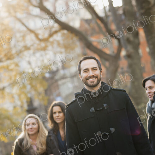 Adult group in urban park, man in front Adult group in urban park, man in front