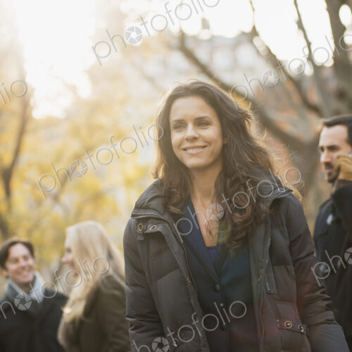 Adult group in urban park, woman in front