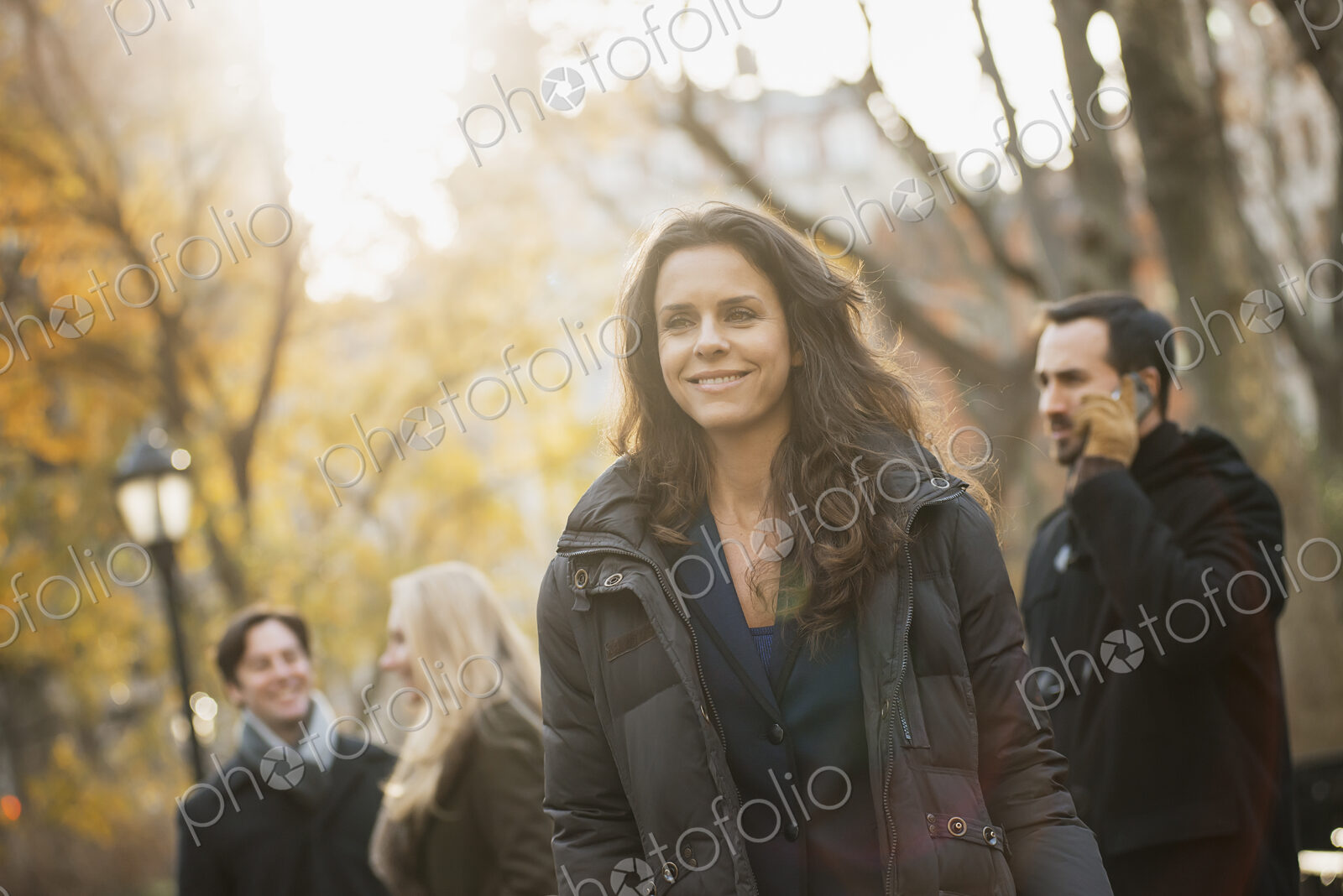 Adult group in urban park, woman in front