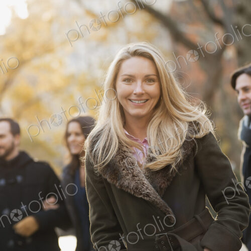 Adult group in urban park, woman in front