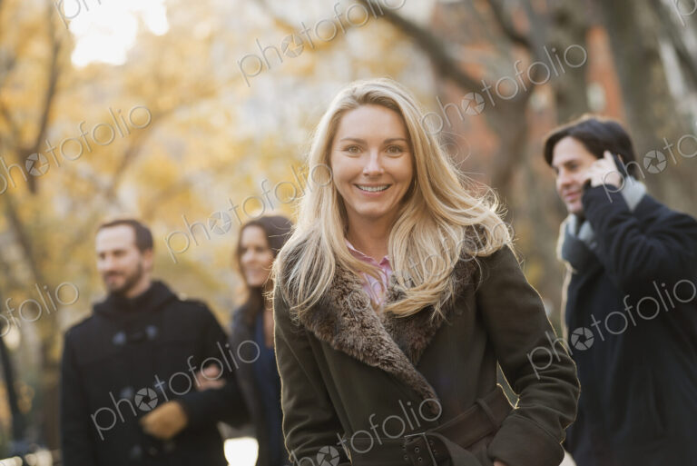 Adult group in urban park, woman in front