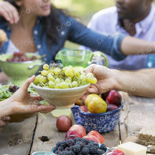 Adults and children around a table at a party in a garden.