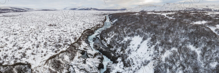 Aerial View of Barnafoss on the river Hvítá, white water cascading down a narrow gorge…