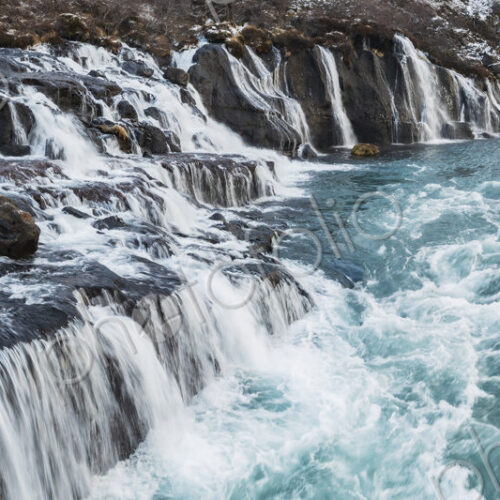 Aerial View of Hraunfossar on the Hvita River, a series of cascades into the fast… Aerial View of Hraunfossar on the Hvita River, a series of cascades into the fast…