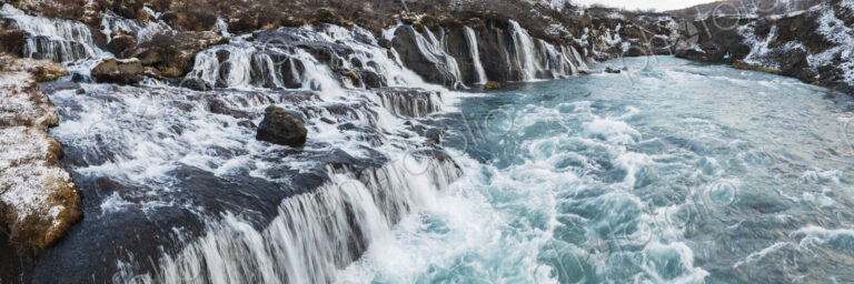 Aerial View of Hraunfossar on the Hvita River, a series of cascades into the fast…