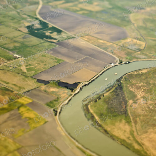 Aerial View of a River Passing Through Farmland Aerial View of a River Passing Through Farmland