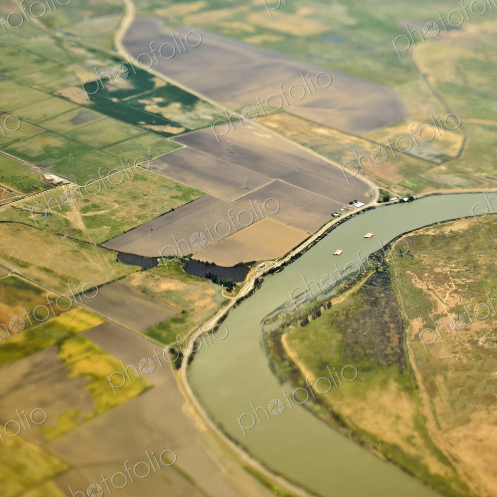 Aerial View of a River Passing Through Farmland