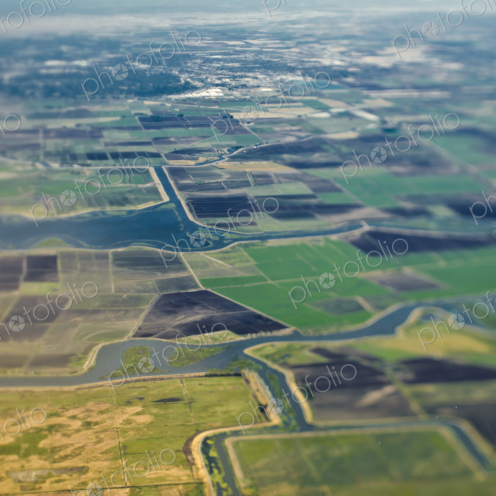 Aerial View of a River Passing Through Farmland