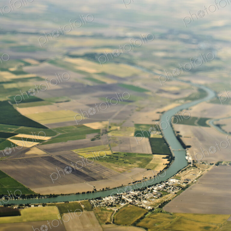 Aerial View of a River Passing Through Farmland