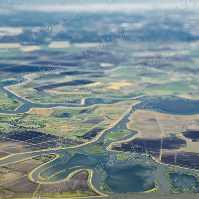 Aerial View of a River Passing Through Farmland