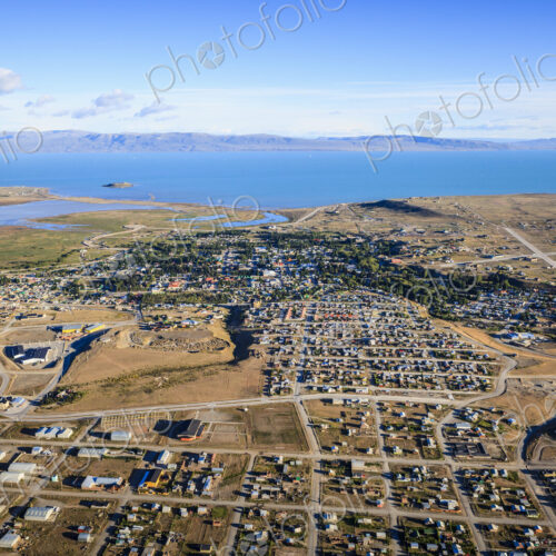 Aerial view of El Calafate, a sprawing town on the coast, a sea channel, on the edge… Aerial view of El Calafate, a sprawing town on the coast, a sea channel, on the edge…