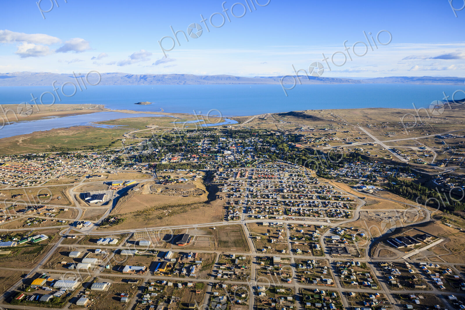 Aerial view of El Calafate, a sprawing town on the coast, a sea channel, on the edge…