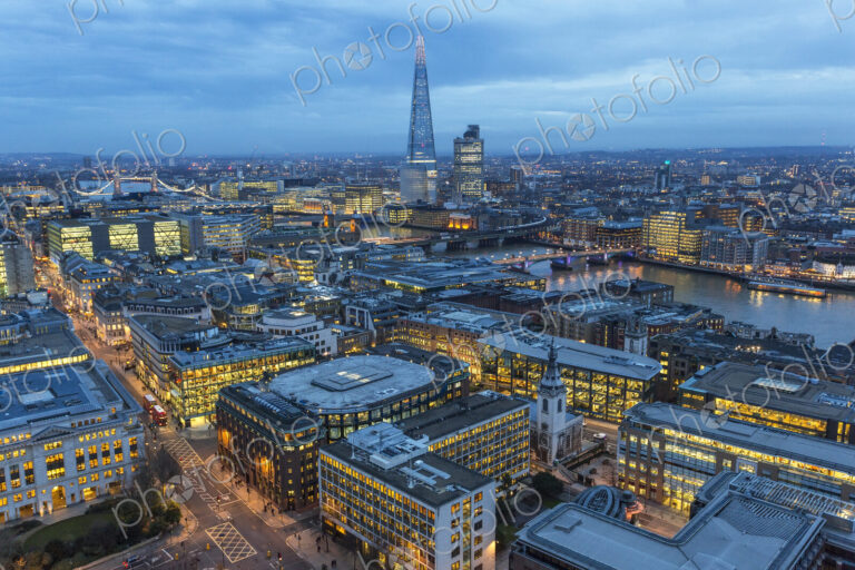 Aerial view of London, UK in the evening, with river Thames and the Shard in the distance.