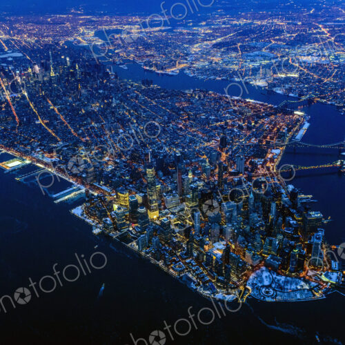 Aerial view of Manhattan cityscape and river at night, New York, United States Aerial view of Manhattan cityscape and river at night, New York, United States