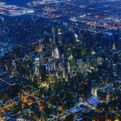 Aerial view of Manhattan cityscape and river at night, New York, United States Aerial view of Manhattan cityscape and river at night, New York, United States